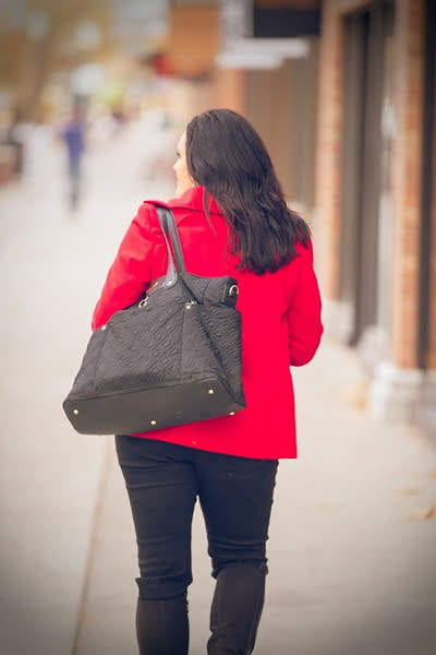 Professional woman walking down a city sidewalk, representing independence and career transition for myo therapists and myofunctional therapists