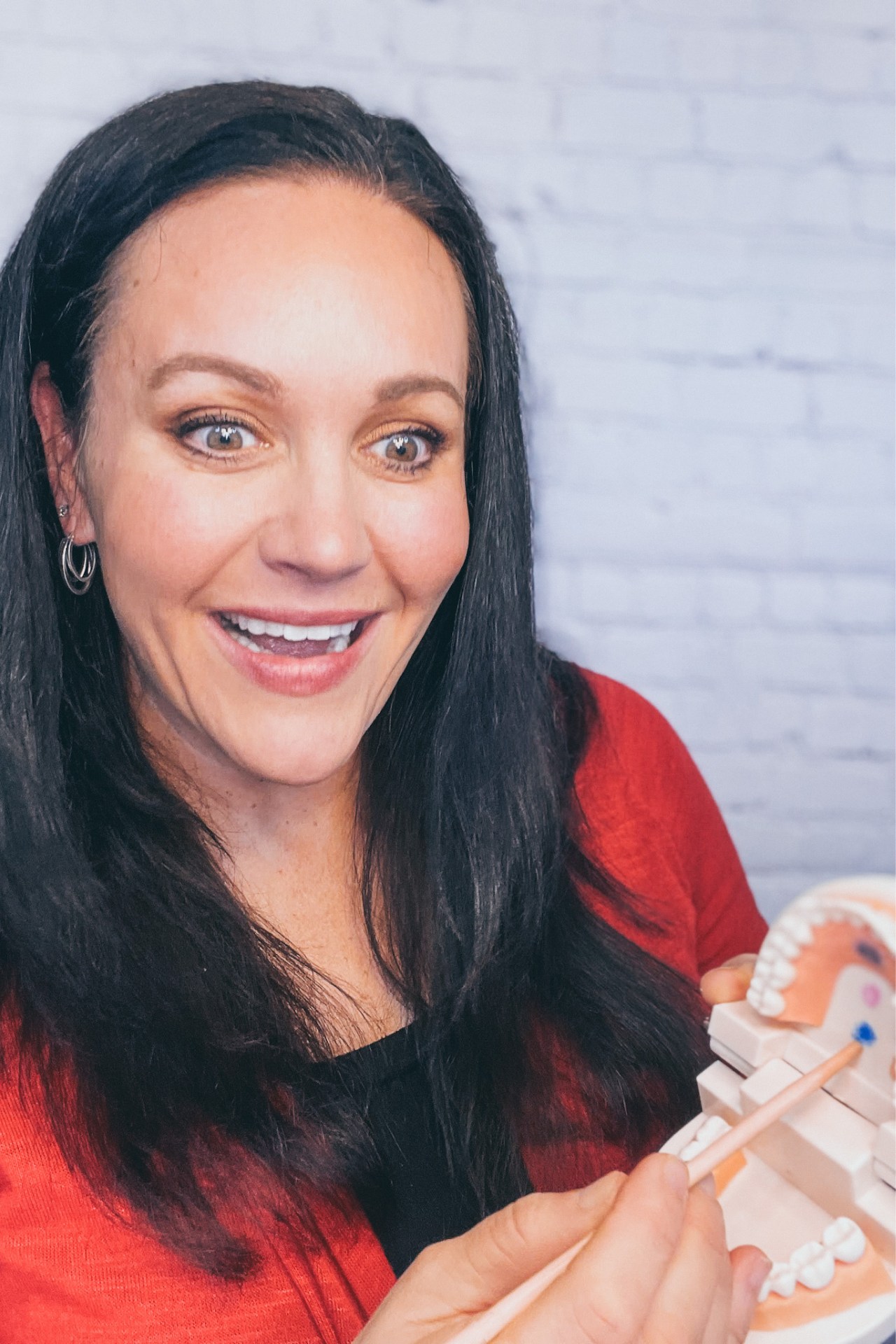 Carmen Ball demonstrating myofunctional therapy training techniques with a dental model